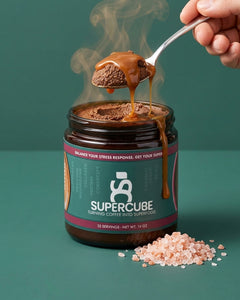 SuperCube Salted Caramel limited batch jar with a spoonful of cube and caramel drizzle beside Himalayan pink salt